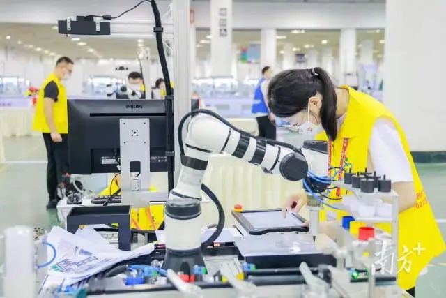 深圳信息职业技术学院学生进行工业现场编程调试。 图片